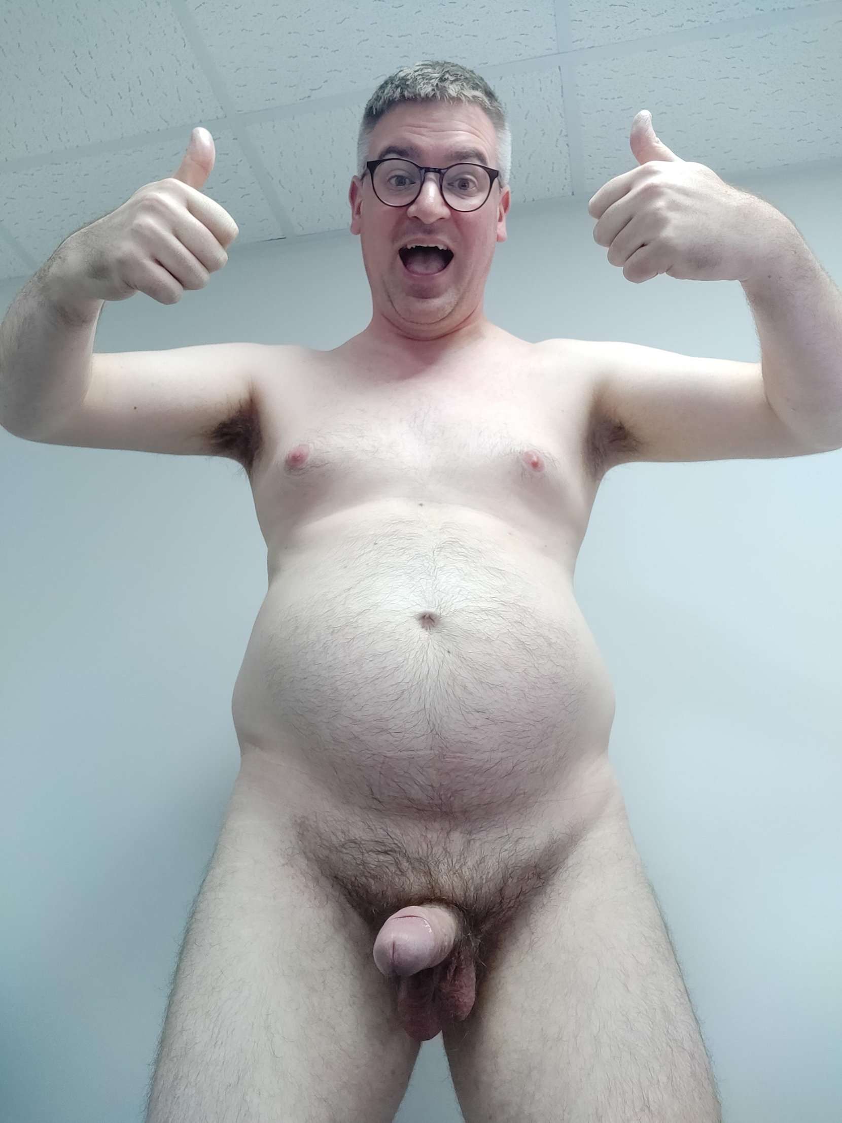 Man with big smile and thumbs up, exposing genitals